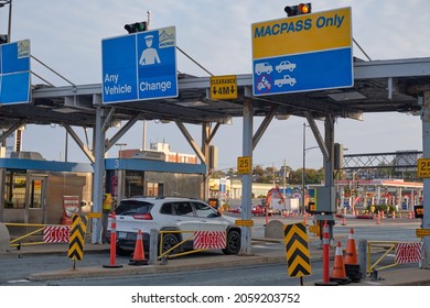 Car pulling up at the Toll Booth on McDonald Bridge over Halifax Harbour. Darmouth, Canada. October, 11, 2021