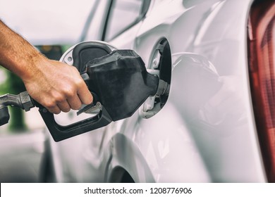 Car Pumping Gas At Gas Pump. Closeup Of Man Pumping Gasoline Fuel In Car At Gas Station.