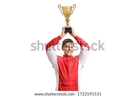 Car racer holding a gold trophy cup and smiling isolated on white background