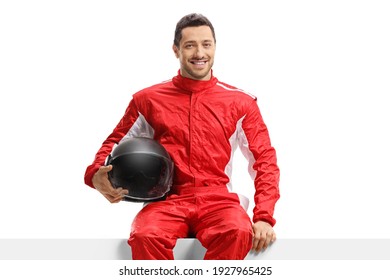 Car Racer In A Red Uniform Sitting On A Panel Holding A Helmet Isolated On White Background