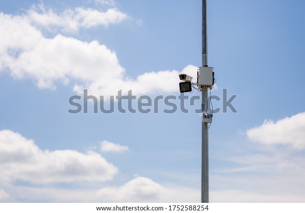 car radar - a device\
for measuring the speed of a car, hanging on a pole on the track.\
security camera
