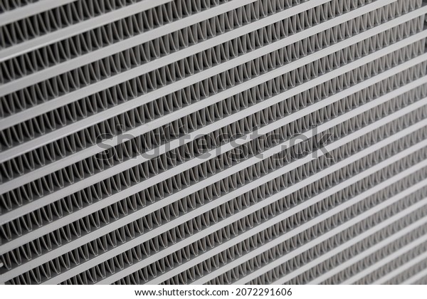 Car radiator\
background. Engine cooler background. Vintage style.Grid radiator\
air conditioning, close-up
