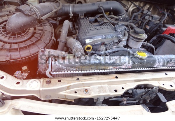 Car radiators have cracks, causing chemicals such\
as acid, distilled water to splash out and mess up the engine room\
of the car. Dirty in the engine close up concept. Car to be\
repaired in the garage.