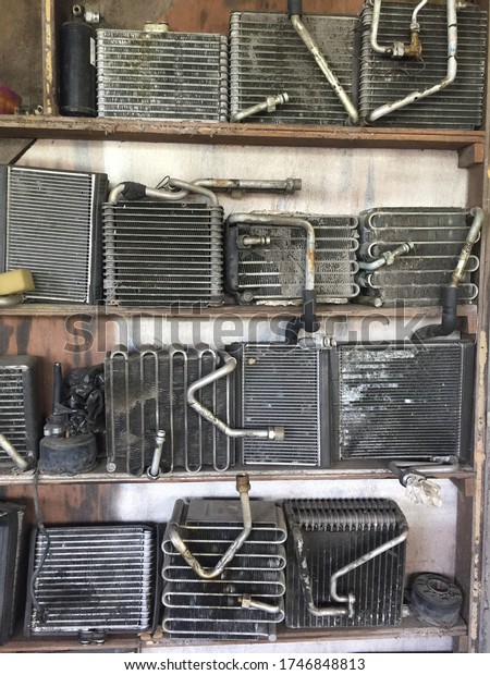 Car radiators scrap in mechanic\
workshop. Radiator is one of the main part in car\
engine.