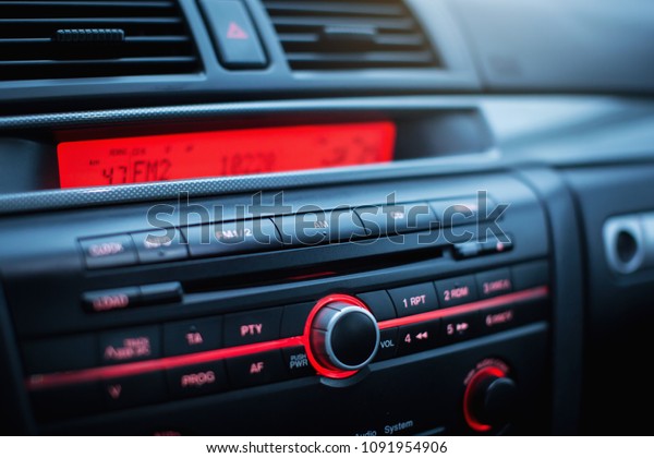 Car radio and air conditioner system. Button on\
dashboard in modern car\
panel.