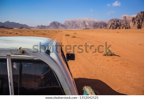 car rally tour speed fuzzy\
sand track in desert scenery landscape navigator concept\
photography