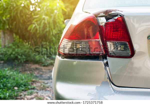 Car rear light with bumper scrash and\
broken by accident on road,Car insurance\
concept