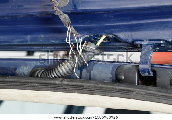 car. rear trunk lid. wire damage. they are\
naked. very dangerous. car can\
burn
