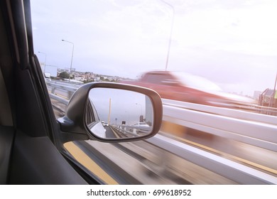 Car Rear View Mirror While Running On The Road.