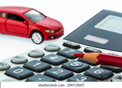 a car and a red pen is on a calculator. cost of gasoline, wear and insurance. car costs are not paid by commuter tax.