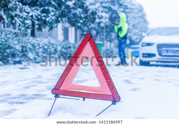 Car red triangle in winter. Emergency sign. Broken\
car on highwa