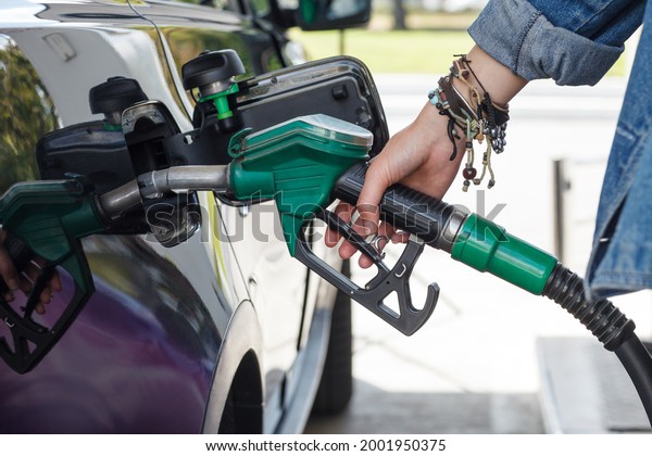 Car refueling in filling\
station.