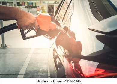 Car Refueling Fuel On Petrol Station. Man Pumping Gasoline Oil. Service Is Filling Gas Or Biodiesel Into The Tank. Automotive Industry Or Transportation Concept