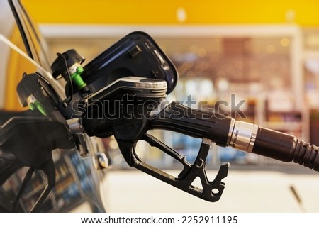 Car refuelling on the petrol station. Close up view. Fuel, gasoline, diesel is getting more expensive. Petrol industry and service. Petrol price and oil crisis concept
