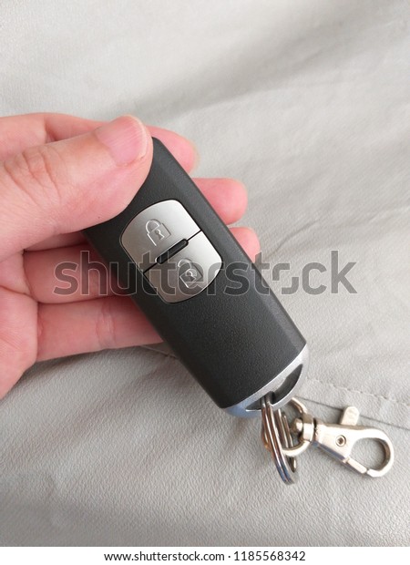 Car remote control keyless with two buttons\
(unlock and lock), Pressing a button on the key unlocks the car\
doors and another button locks the\
car
