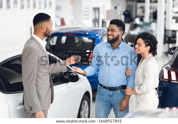 Car Rental Concept Afro Couple Taking Stock Photo (Edit Now) 1668927841