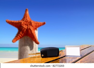 Car Rental Keys On Wood Table With Blank Paper In Vacation With Starfish Of Caribbean Beach [Photo Illustration]