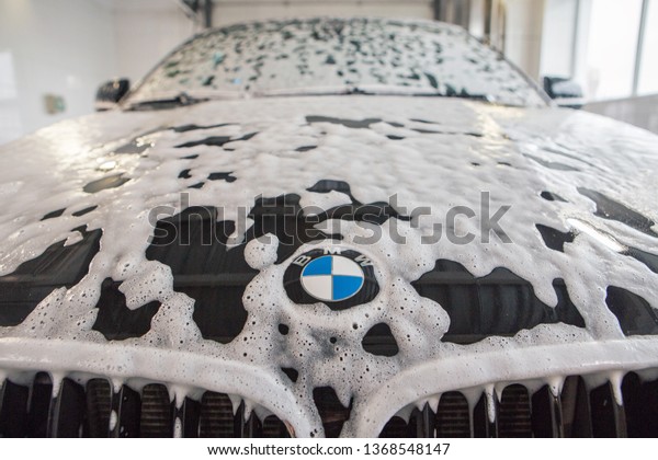 car repair car advertising car wash, BMW advertising,\
Moscow, 1.11.2018: BMW motor company badge in front of the black\
car. 