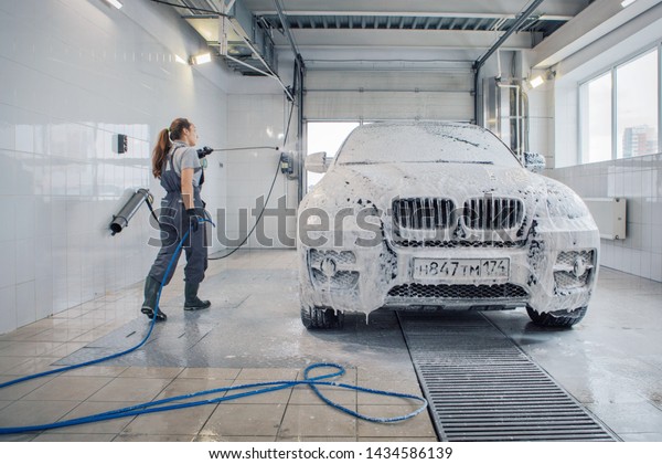 car repair car advertising car wash, BMW\
advertising, Moscow, 1.11.2018: BMW motor company badge in front of\
the black car. BMW-German company for the production of cars,\
motorcycles and engines
