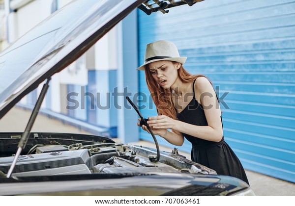 Car, repair, body shop, a woman peeks into the
hood                              
