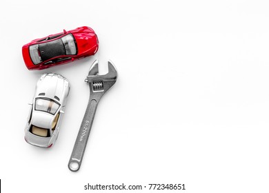 Car Repair Concept. Wrench Near Car Toys On White Background Top View Copyspace