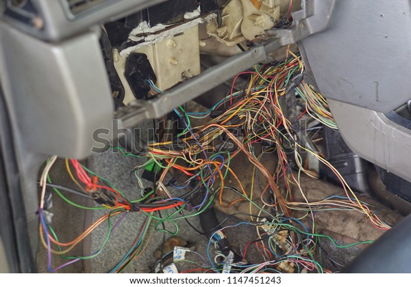 car repair & electric\
wiring system showing colorful wire in old car, interior view.Close\
up.