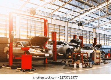 car repair in garage service station with soft-focus and over light in the background - Powered by Shutterstock