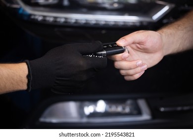 Car Repair. Man Owner Of The Auto Gives The Keys To The Car Repairman. Vehicle Breaks Down. Close Up Shot Of Hands Of Male Client Giving Car Key To Mechanic In Auto Repair Shop