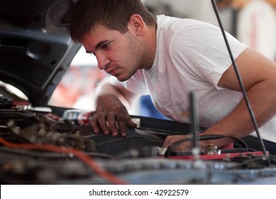 Car Repair Mechanic Fixing Auto. Man Working On Car In Garage. At Home Do It Yourself. Examine / Inspect Engine Compartment For Trouble; Diagnose And Fix / Correct Problem; Preventative Maintenance.