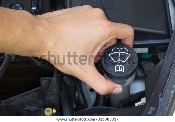 Car repair service, Auto mechanic checking water\
level in a engine