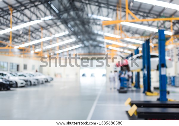 Car repair service center the epoxy floor in car\
factory service  , The interior of a big industrial building or\
factory with steel constructions.,Steel roof frame , blurred\
background for industry