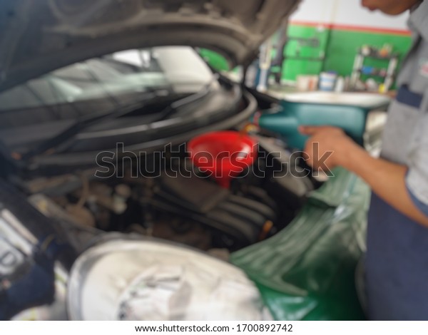 car repair\
shop and change tire, blurred\
image