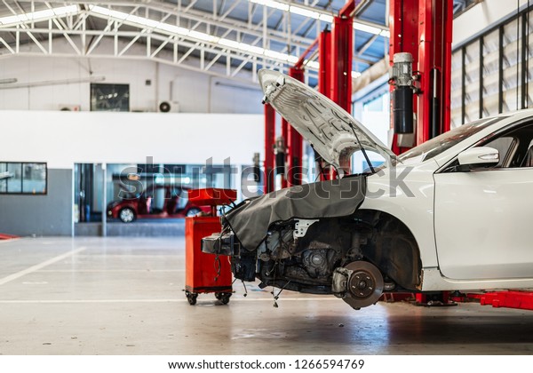 car in repair station and body shop with\
soft-focus and over light in the\
background
