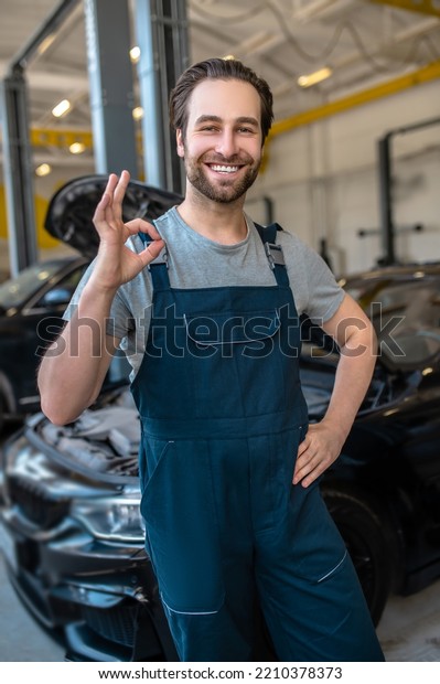 Car\
repair worker posing for the camera in the\
workplace