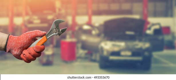 Car Repairing,Hand Of Technician Auto Mechanic With A Wrench Working In Garage. Service In Auto Repair Station.vintage Tone,for Banner