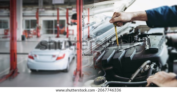 Car Repairman is Checking Engine Oil Level in\
Automotive Workshop, Maintenance Car Worker Inspection Checkup Oil\
Vehicle Engines by Dipstick Test at Automobile Shop Station. Auto\
Car Services