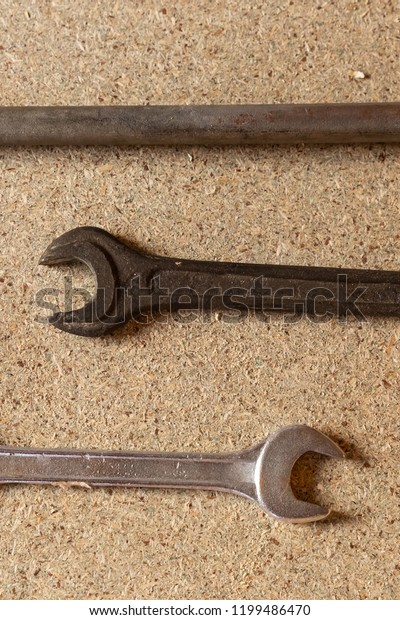 car repairs. Tools for repair wrenches lie on a\
light background, three\
keys
