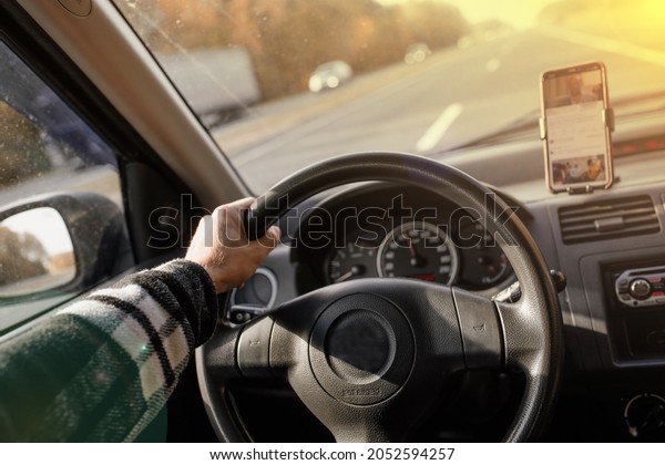 car\
ride, car driver driving, hand on steering\
wheel