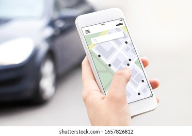 Car or ride share mobile app in smartphone. Carsharing, ridesharing or carpool service. Sharing economy concept. Person ordering taxi online with phone. Map location in screen. Automobile rent system.