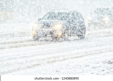 Car Rides Through A Snowstorm. Limited Vision On The Road. Blizzard - Car Traffic In Bad Weather Conditions