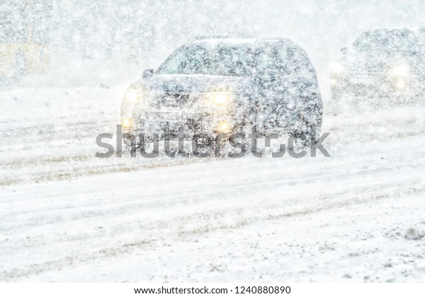 Car rides through a\
snowstorm. Limited vision on the road. Blizzard - car traffic in\
bad weather conditions