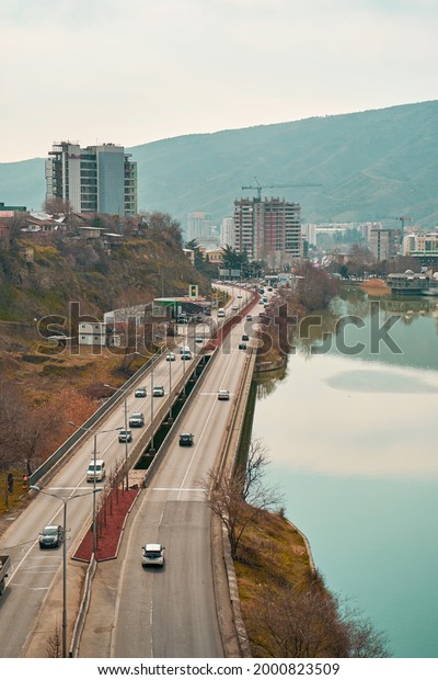 Car road on the bank of the river. Tbilisi,\
Georgia - 03.17.2021