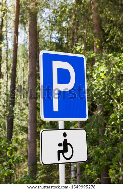 car road sign indicating the place for Parking a\
car for the disabled, white letter P on a blue background, traffic\
control on the roads