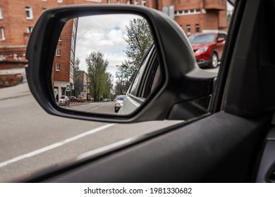 Car Road Trip Concept. Car Driving Conceptual Photo. Outside Mirror. Objects in mirror are closer than they appear  with Blind Spot Assist Warning LED Sensor Light