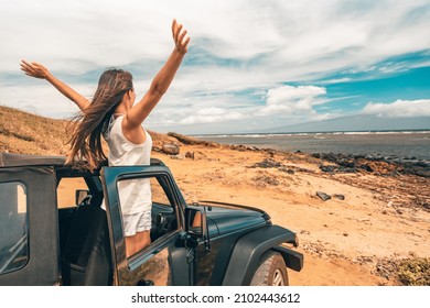 Car Road Trip Travel Fun Happy Woman Tourist With Open Arms At Ocean View From Sports Utility Car Driving On Beach. Summer Vacation Adventure Girl From The Back.