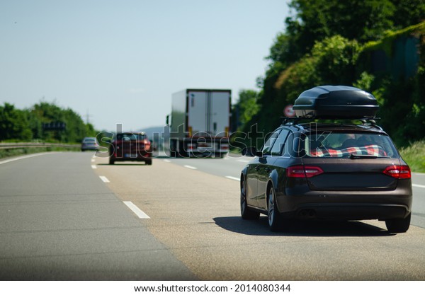 Car with roof box on\
Germany autobahn 