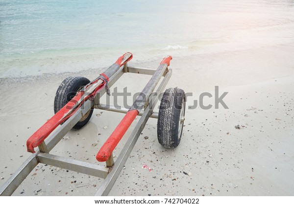 Car root\
ships or boat trailer in the seaside , components trailer for boats\
roots , a close-up trailer hook for\
boats.