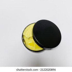 Car Rubbing compound in black container isolated on white background
