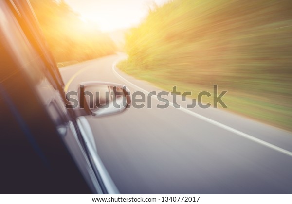 car is running on the road, looking from\
inside the car in the morning in blur\
picture.