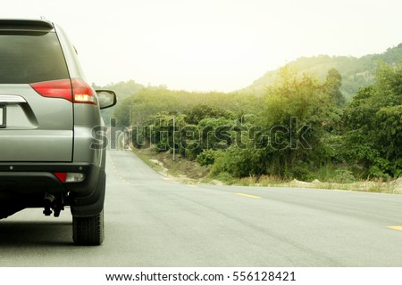Car running on the road for travel trip have mountain and tree before to mountain. in Rayong Thailand.